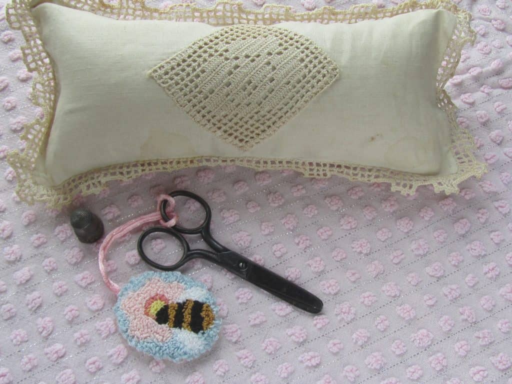 antique pin cushion with scissors and punched bee scissor fob