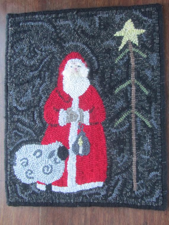hooked rug with a Santa, sheep and tree