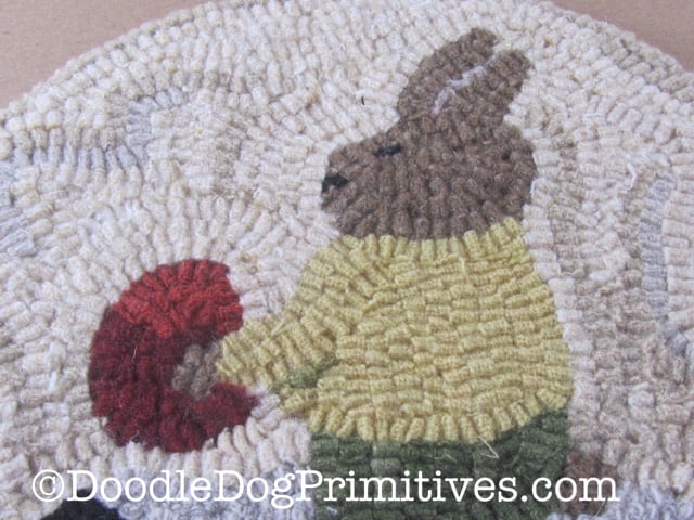 Close-up of bunny with egg in the hooked rug