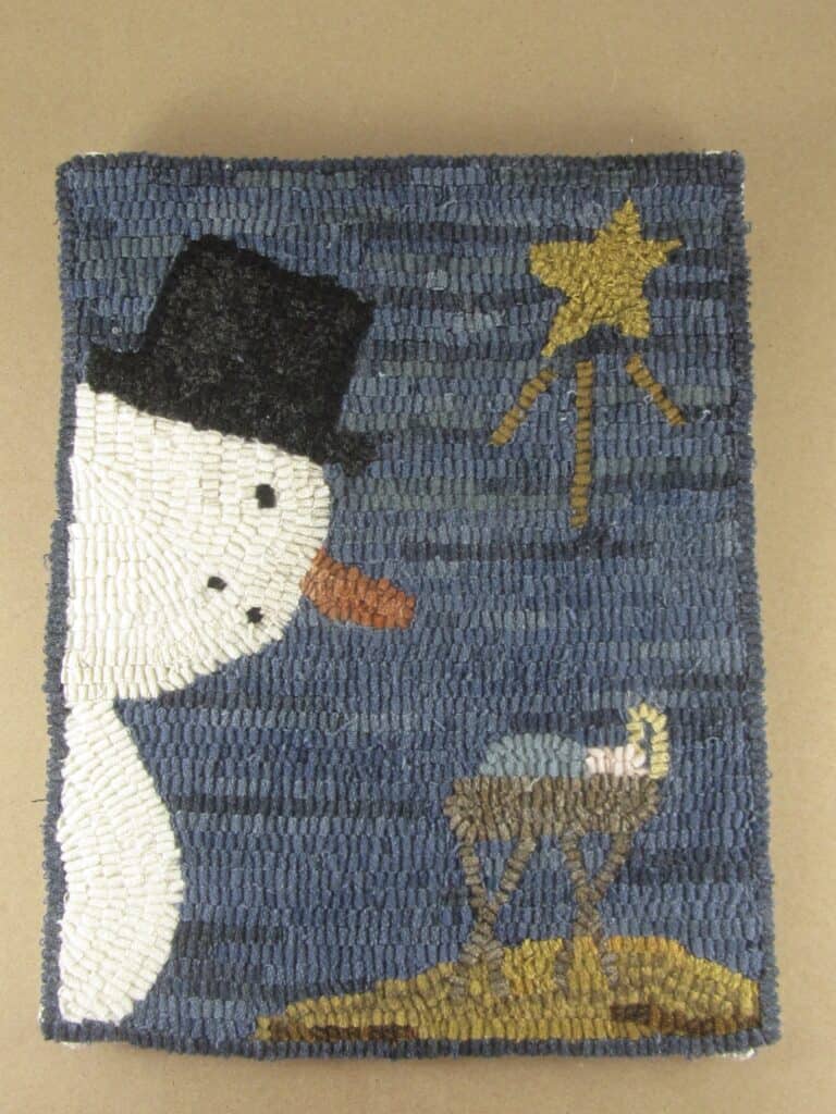 hooked rug snowman looking at manger