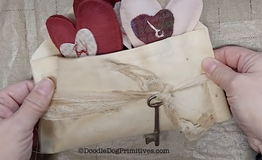 add cheesecloth to Valentine heart envelope