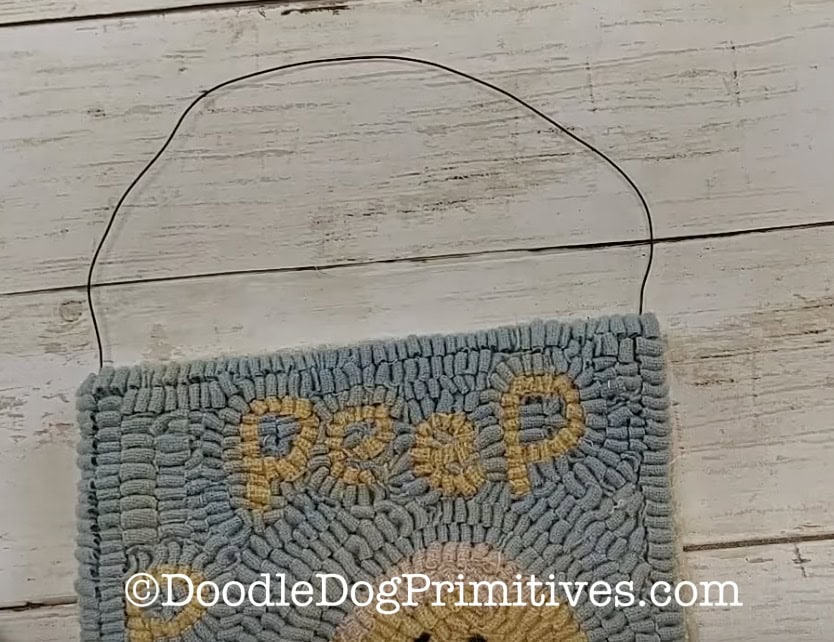 add wire hanger to rug hooking project